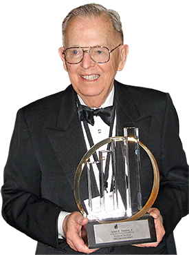Jim Stowers holding an award