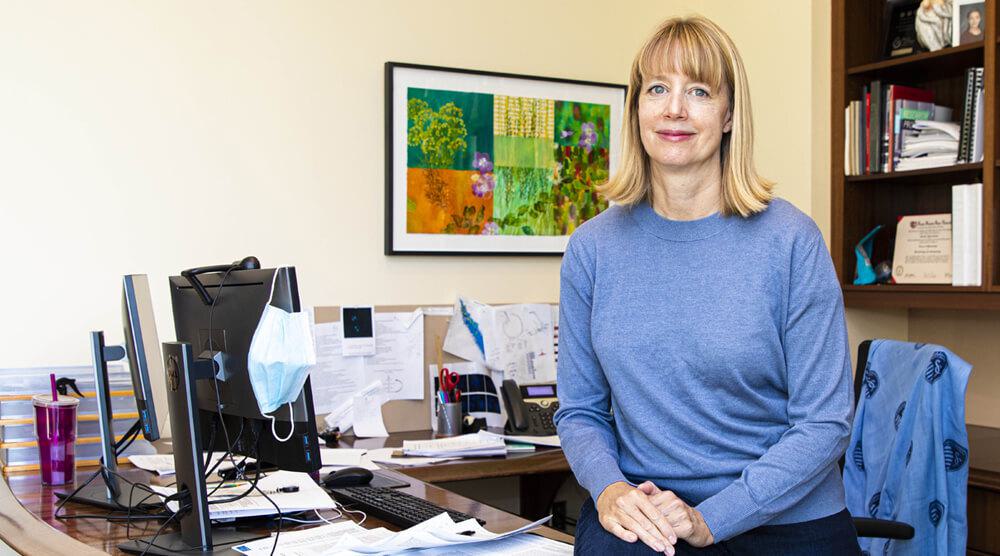 Stowers Investigator Jen Gerton, PhD, sitting at a desk in an office