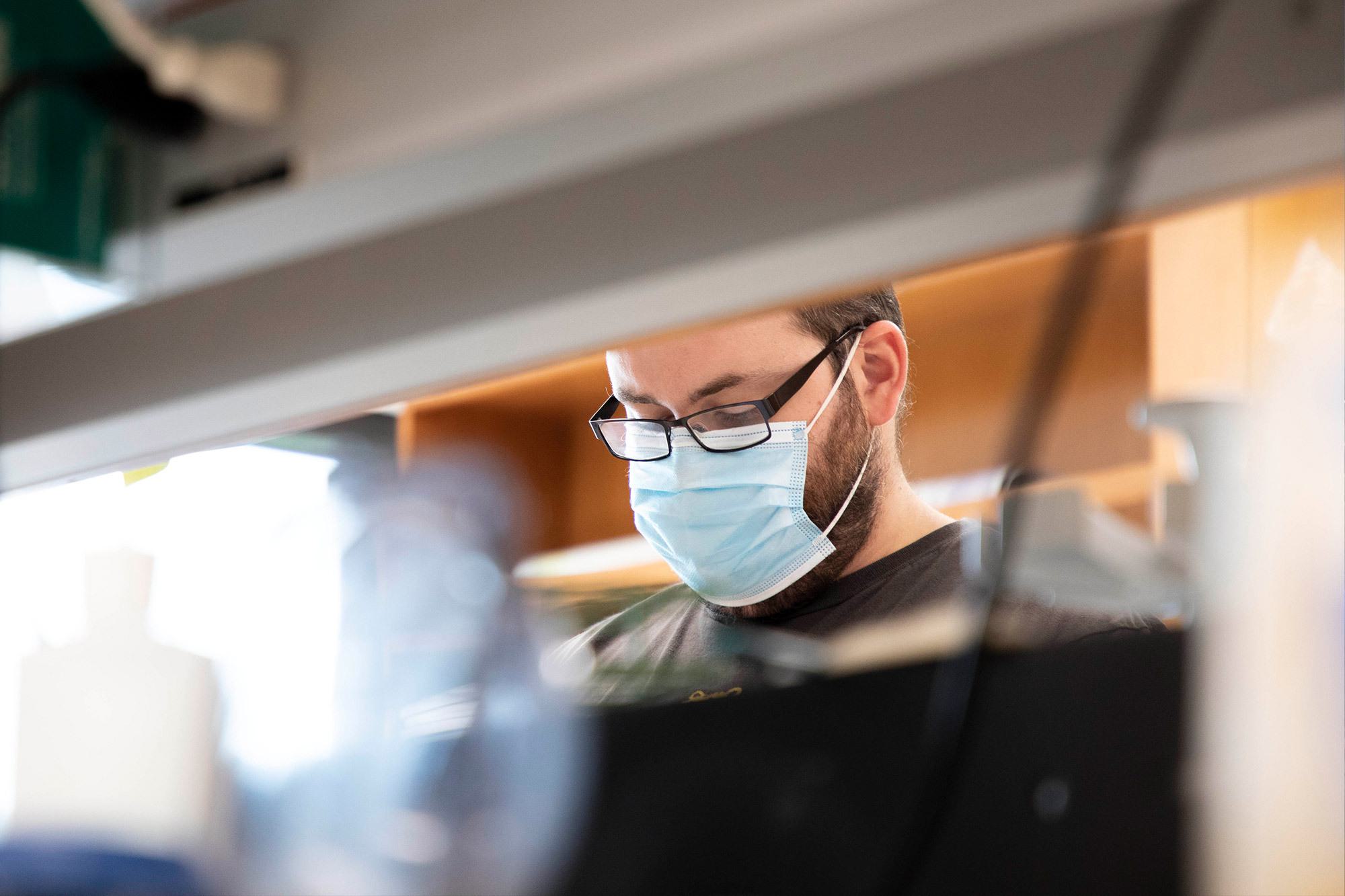 scientist with beard, glasses and face mask